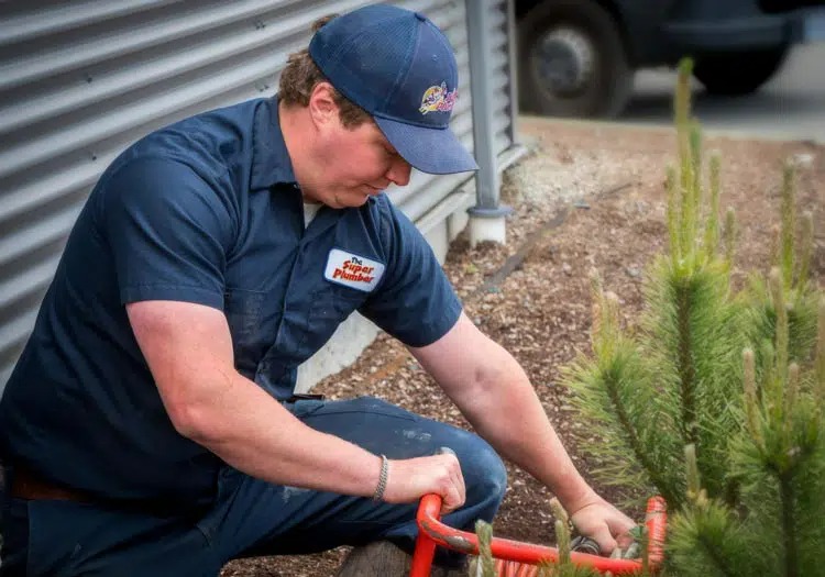 A picture of a Super Plumber team member providing drainage service