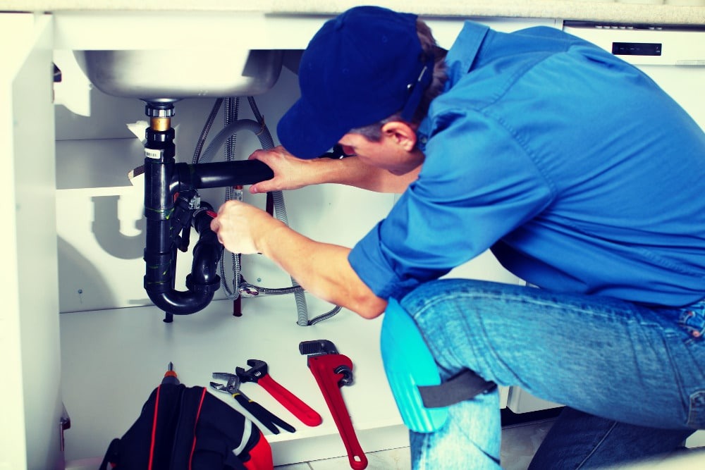 plumber repairing sink